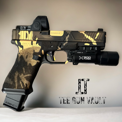 AGENCY ARMS GLOCK 17 MULTI CAM BLACK & GOLD WITH TIMNEY (PRE OWNED)